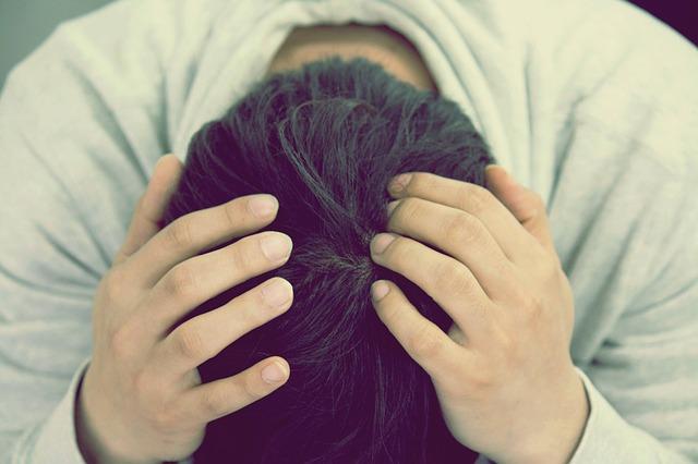 pessoa com a mão na cabeça por saúde mental afetada na quaretena